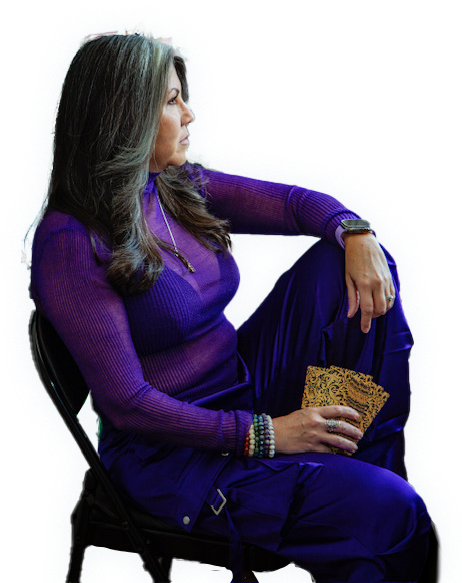 Portrait of Norely sitting with her Tarot cards